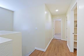 Glendale townhouse for rent - a renovated living room and hallway with white walls and wood flooring