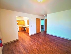 Williamson apartment for rent - an empty living room with a hard wood floor and a kitchen
