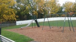 Clyde apartment for rent - a swing set on a playground in a park