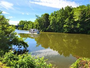 Lyons apartment for rent - a boat on a river with a bridge in the background