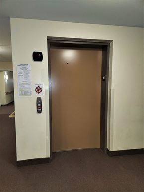 Lyons apartment for rent - an open elevator door in an office building