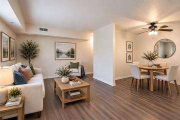 Alexandria apartment for rent - A living room with a white couch, a wooden coffee table, and a dining table with chairs.