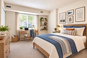 Alexandria apartment for rent - A bedroom with a bed, desk, chair, and window.