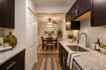 Alexandria apartment for rent - A kitchen with a dining table and chairs in the middle.