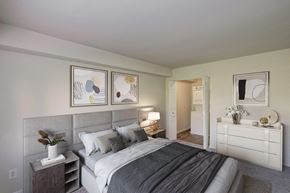 Alexandria apartment for rent - A bedroom with a large bed and a white dresser.
