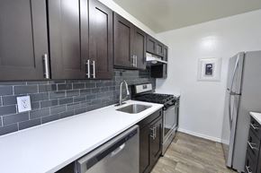Alexandria apartment for rent - a kitchen with stainless steel appliances and wooden cabinets