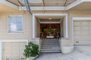 San Francisco apartment for rent - A white garage door is on the left of a house entrance.