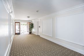 San Francisco apartment for rent - A long hallway with a carpeted floor and white walls.