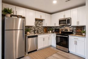 Nashville apartment for rent - A kitchen with a stainless steel refrigerator and white cabinets.