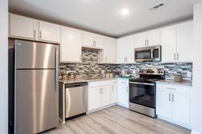 Nashville apartment for rent - a kitchen with stainless steel appliances and white cabinets