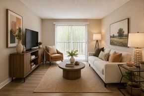 Nashville apartment for rent - A living room with a white couch, a wooden coffee table, and a television.
