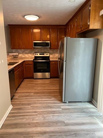Smithfield apartment for rent - A kitchen with a refrigerator, oven, and microwave.
