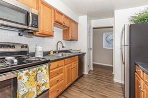 Loveland apartment for rent - a kitchen with stainless steel appliances and wooden cabinets