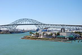 Corpus Christi apartment for rent - A large bridge spans a body of water with a small island in the middle.