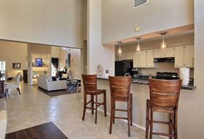 Corpus Christi apartment for rent - A kitchen with a bar stool and a counter.