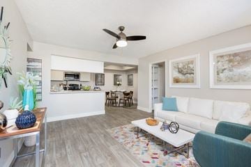 Mesa apartment for rent - A living room with a white couch and a ceiling fan.