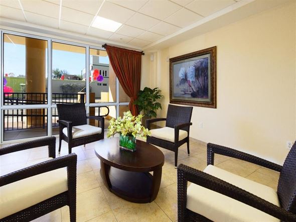 Miami apartment for rent - a living room with a table and chairs and a balcony