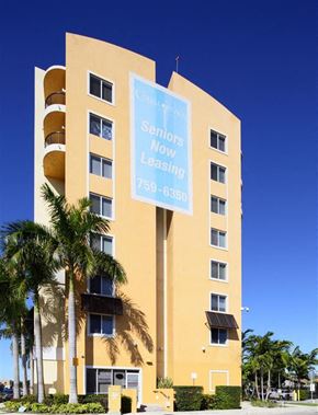 Miami apartment for rent - a large building with a blue sign in front of it
