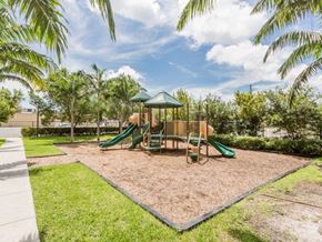 Miami apartment for rent - a playground with a swing set in a park