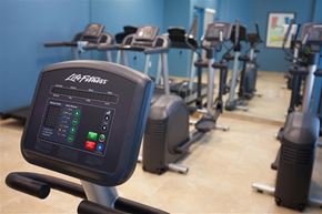 Miami apartment for rent - a row of exercise bikes in a gym with other machines