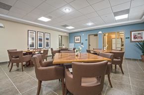 Miami apartment for rent - a dining room with tables and chairs and a kitchen