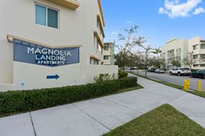 Naranja apartment for rent - a sidewalk in front of a building with a sign for magnolia landing apartments