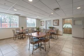 Miami apartment for rent - a dining room with a table and chairs in front of a window