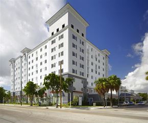 Miami apartment for rent - a large white building on the side of a street