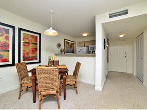 Miami apartment for rent - a dining room with a wooden table and chairs