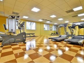 Miami apartment for rent - a gym with a bunch of exercise equipment in it