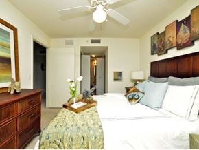 Miami apartment for rent - a bedroom with a large bed and a ceiling fan