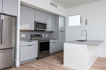 New Orleans apartment for rent - a kitchen with stainless steel appliances and white cabinets