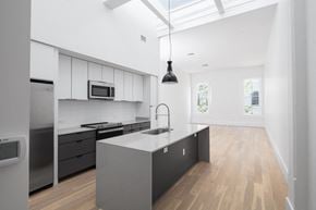New Orleans apartment for rent - a kitchen with a large island and a stainless steel refrigerator
