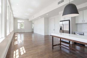 New Orleans apartment for rent - a large white kitchen with a table and a refrigerator