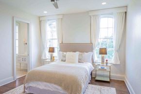 New Orleans apartment for rent - a white bedroom with a bed and two windows
