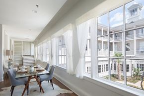New Orleans apartment for rent - a dining room with large windows and a table and chairs