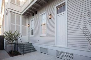 New Orleans apartment for rent - A house with a white door and a small tree in front.