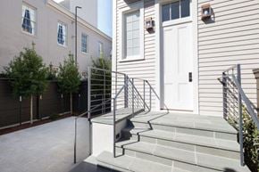 New Orleans apartment for rent - A house with a white door and a grey staircase.