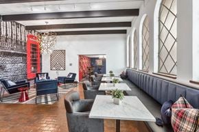 Denver apartment for rent - a dining room with long tables and chairs and a large window
