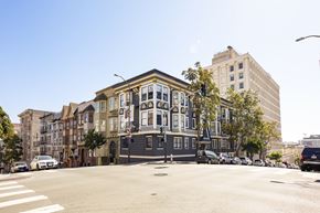 San Francisco apartment for rent - A row of colorful buildings line a city street.