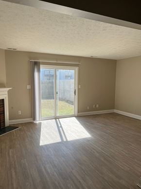 Smithfield apartment for rent - A room with a fireplace and sliding glass doors.