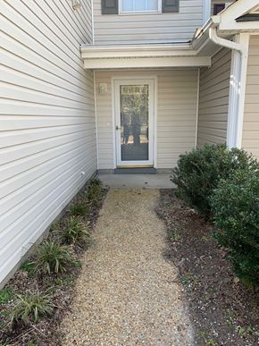 Smithfield apartment for rent - A white door is on the right side of a grey house.