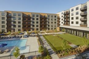 Natick apartment for rent - an aerial view of an apartment complex with a tennis court and a pool