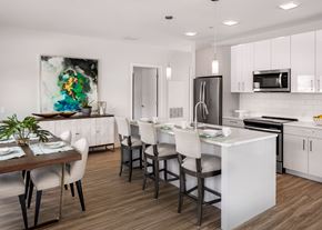 Natick apartment for rent - an open kitchen and dining room with white cabinets and a marble counter top