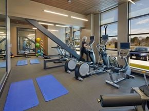 Natick apartment for rent - a woman is on a treadmill in a gym with cardio equipment