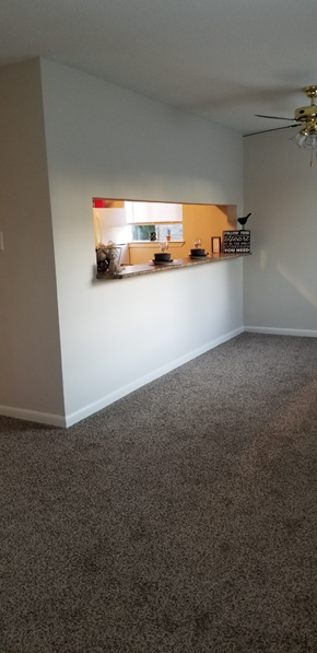 Gautier apartment for rent - a living room with a white wall and a shelf on the wall