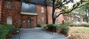 Metairie townhouse for rent - a brick building with a patio and chairs