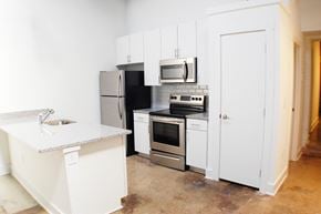 Norfolk apartment for rent - a kitchen with white cabinets and stainless steel appliances