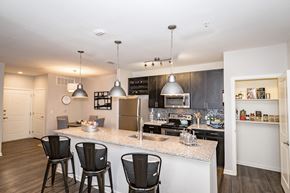 San Antonio apartment for rent - a kitchen with a large counter top with three bar stools