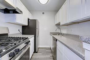 Hyattsville apartment for rent - a kitchen with white cabinets and stainless steel appliances at Avondale Overlook, Hyattsville, MD